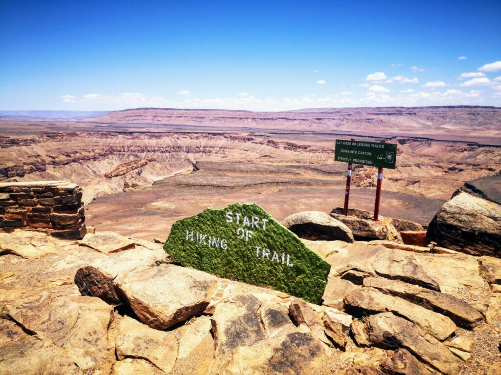 Hikers point at Fish River Canyon