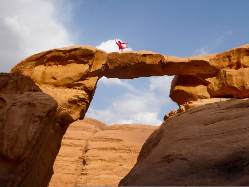 Yoga pose on the natural brigde Um Fruth - Wadi Rum